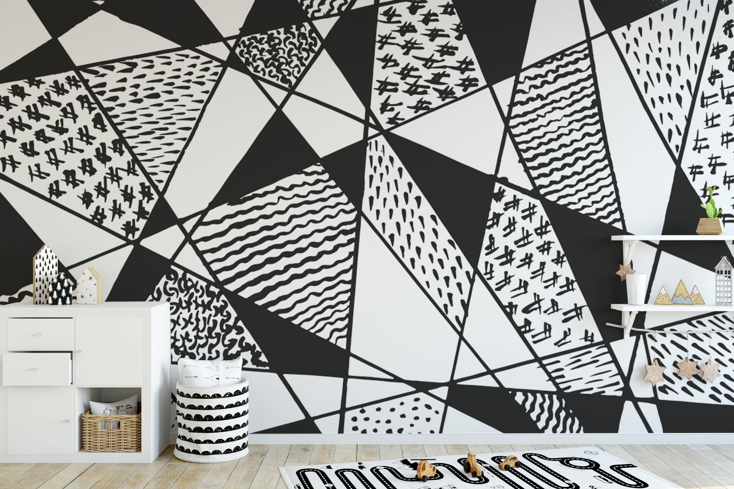 Bold black and white patterns mural with geometric designs.