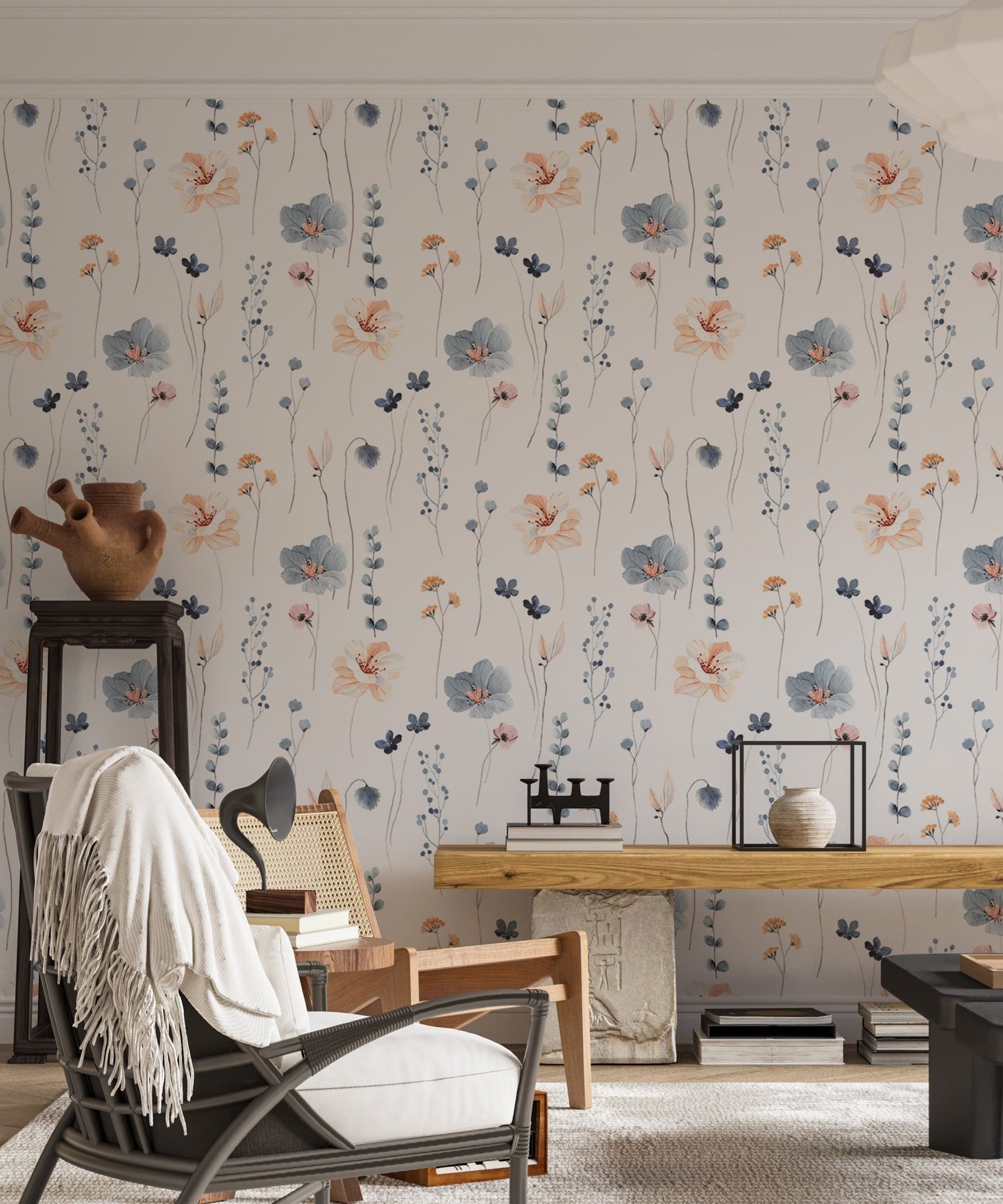 Botanical repeat pattern wallpaper in a living room with a vintage desk lamp.