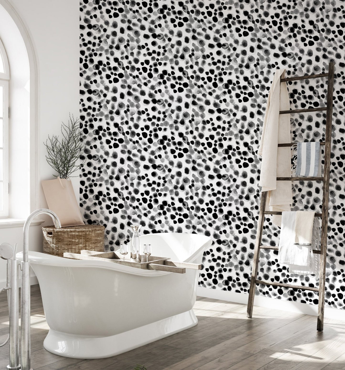 Textured geometric wallpaper in a bathroom with a white freestanding tub.