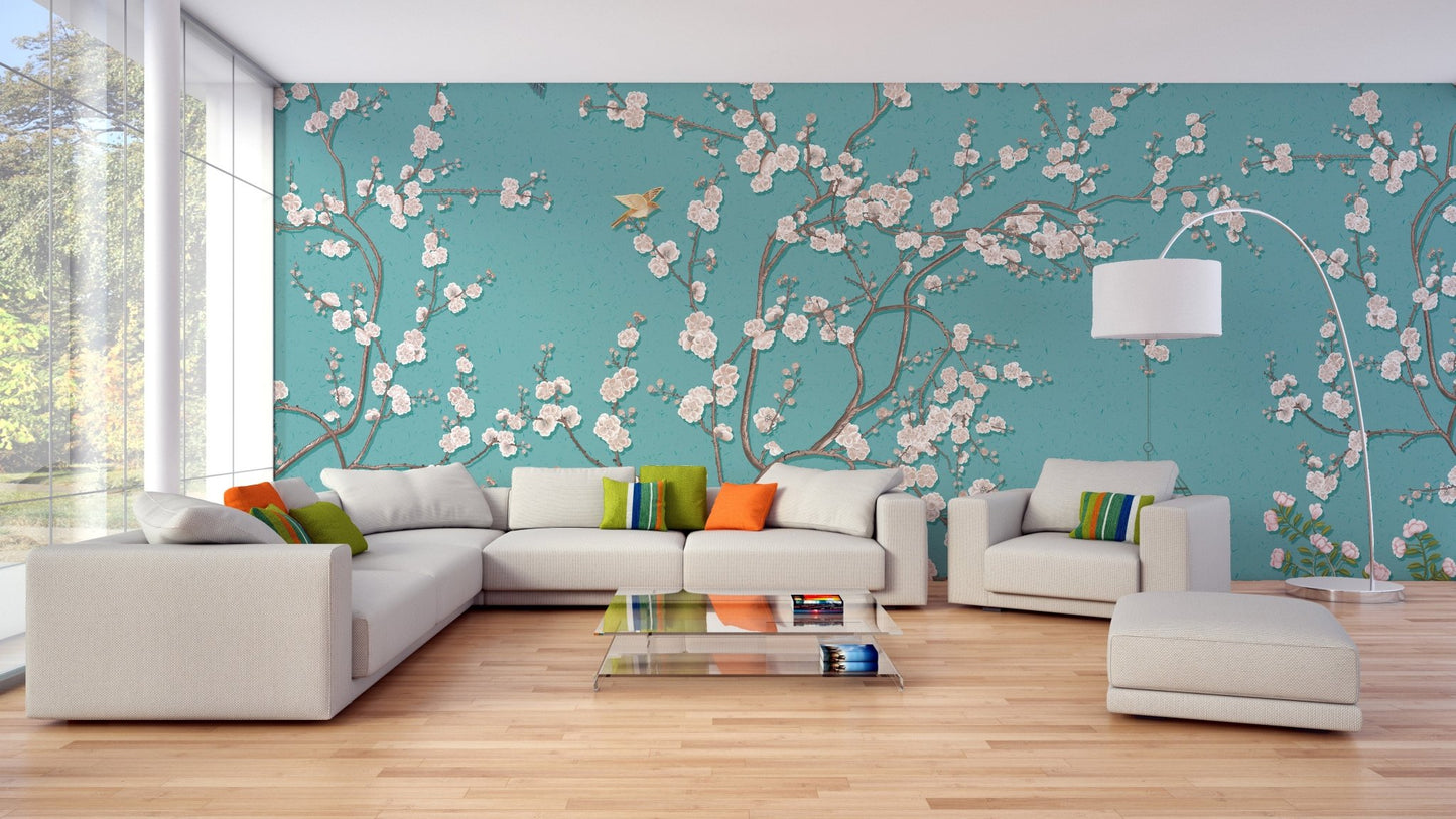 Open plan living area with teal flower wall mural and light wood flooring.