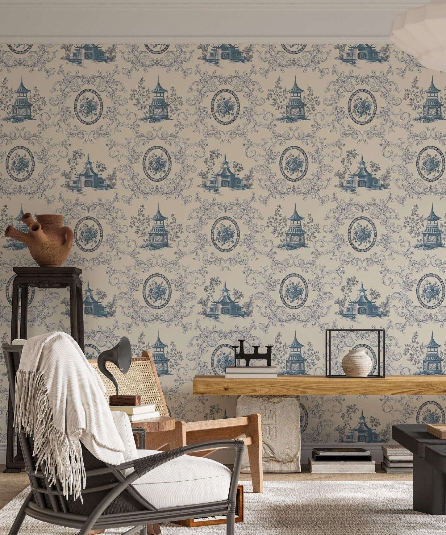 Toile rose flower wallpaper in a study room with a black armchair and white throw.