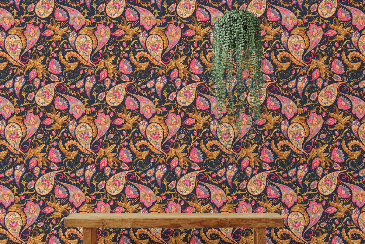 Pink and orange paisley wallpaper behind a simple wooden bench.