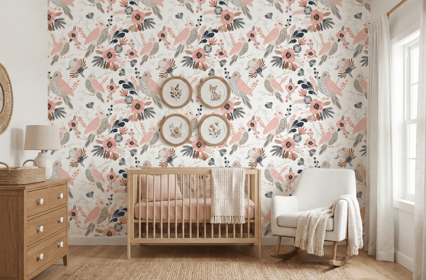 Floral bird wallpaper in baby room with grey nursing chair and wooden dresser.