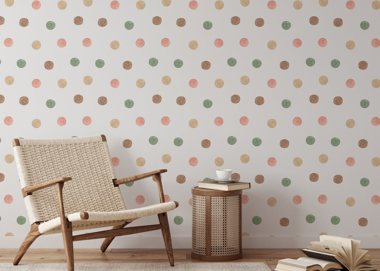 Woven chair next to a wall with earthy watercolor dot wallpaper.
