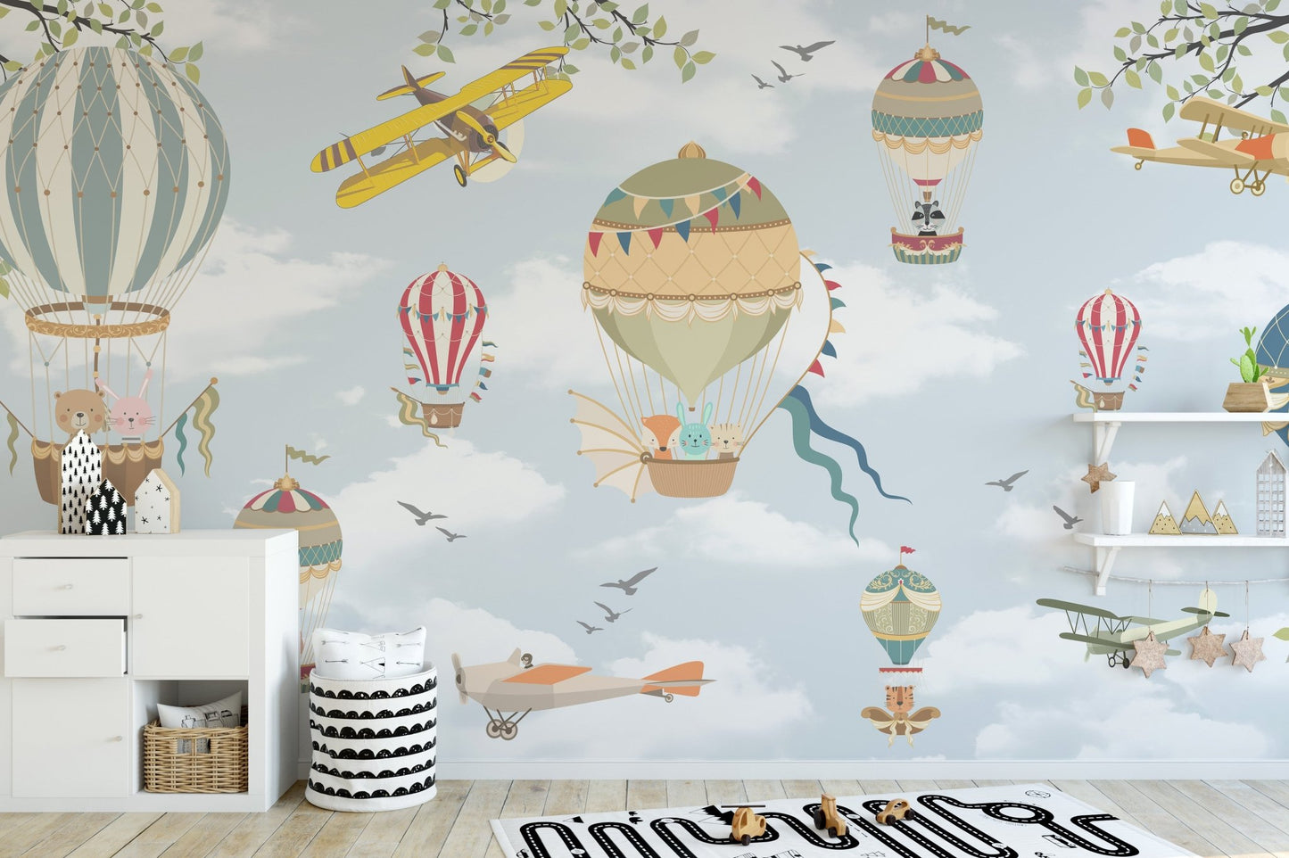 Floating Balloons Kids Wall Mural with white clouds and bunting in nursery.