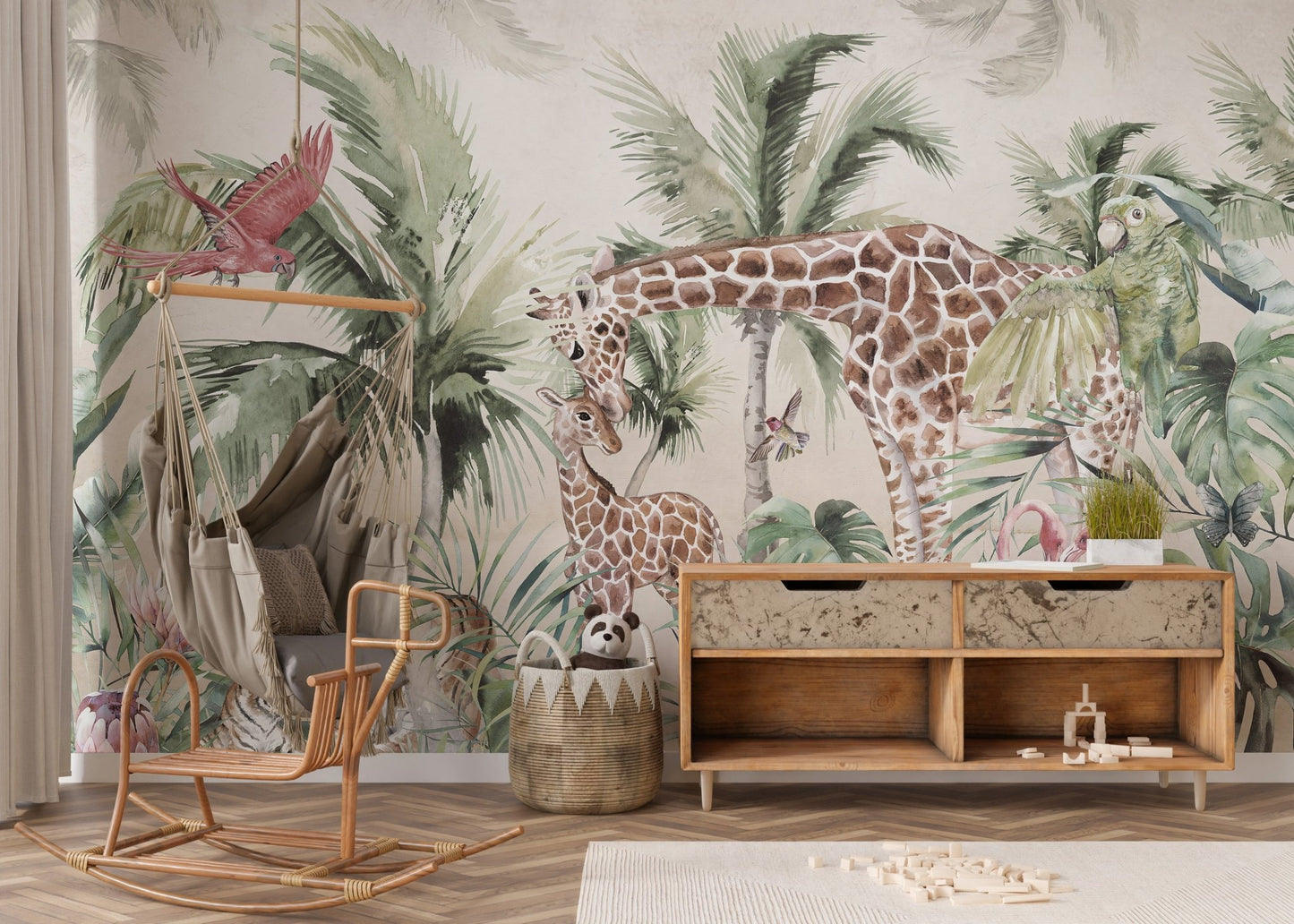 Watercolor palm leaf wall mural with giraffes in a nursery featuring a wooden storage.