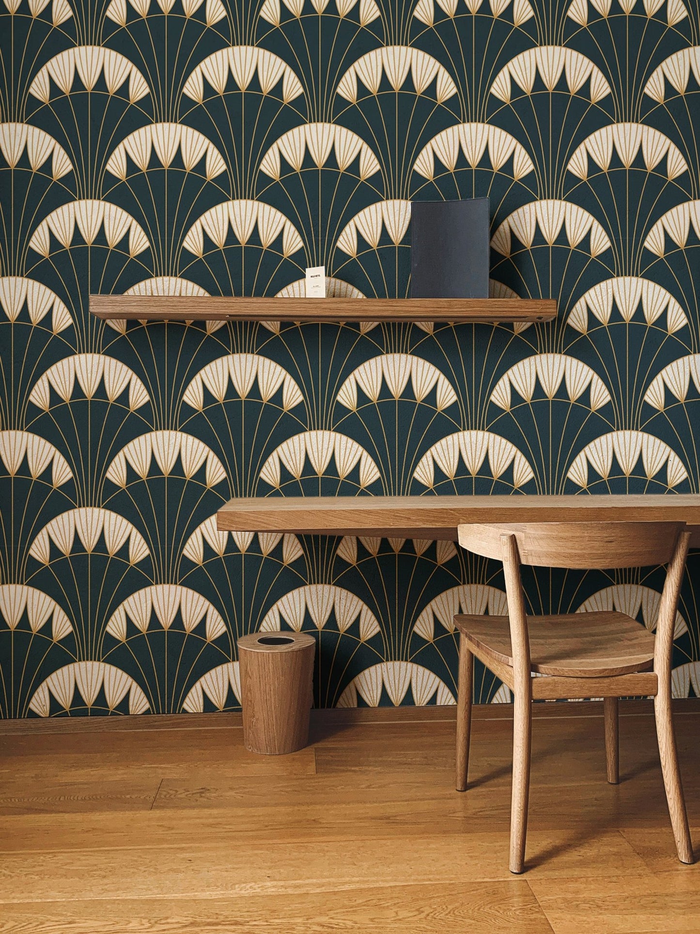 Art Deco green background wallpaper behind wooden study table and chair.