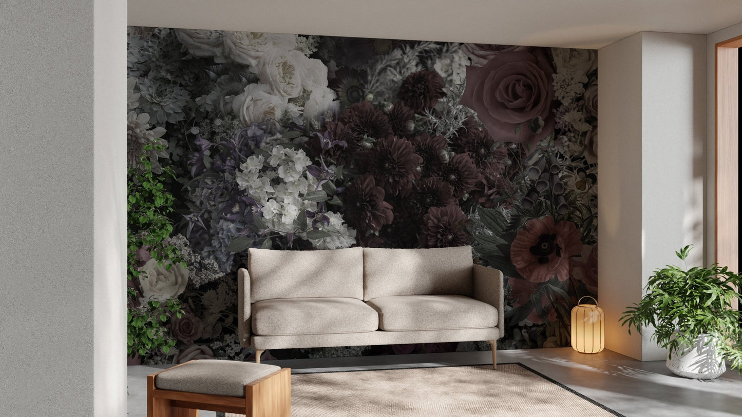 Sunlit living area featuring a tan sofa and dark floral wall mural