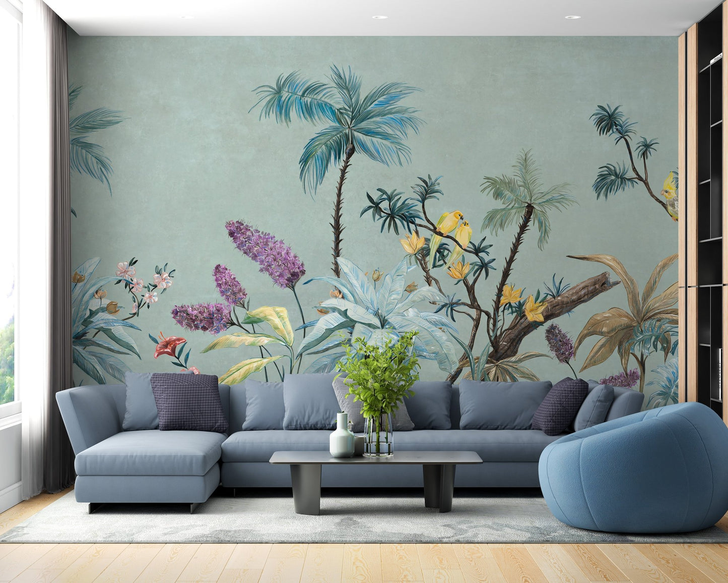 Open plan living room with sage green botanical wall mural and blue couch.