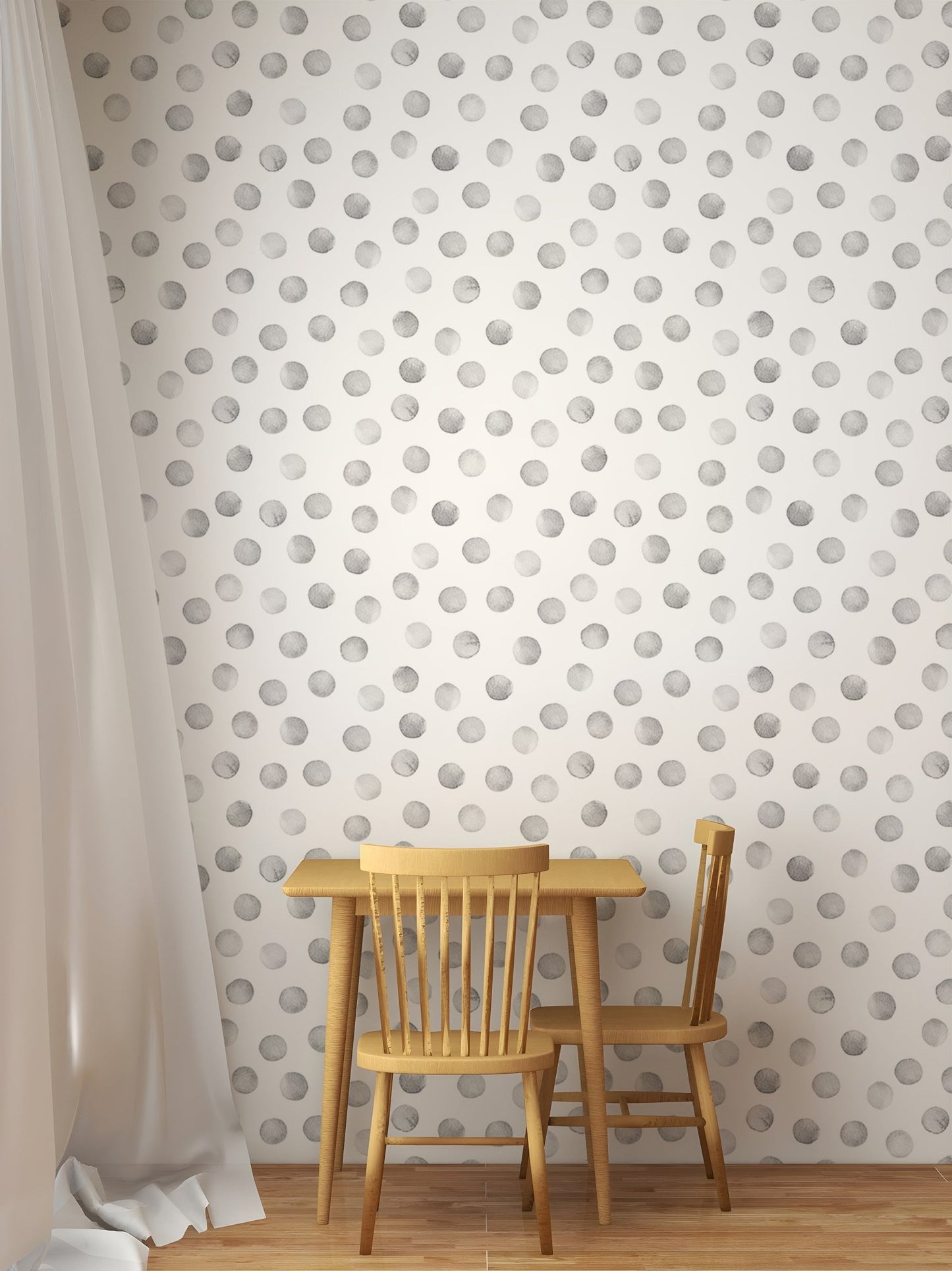 Small wooden table and chairs against a grey polka dot wallpaper.