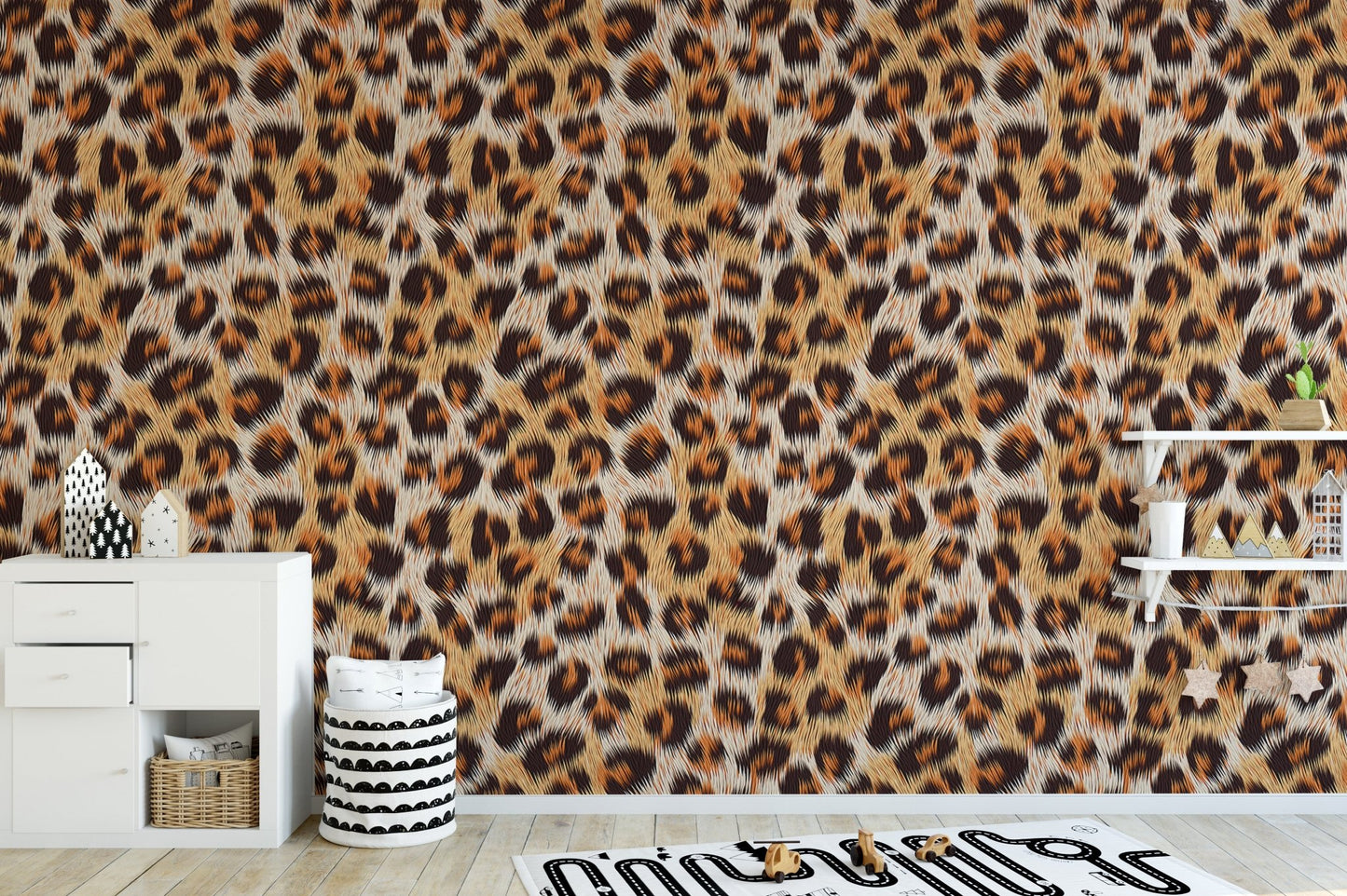 Spotted animal pattern wallpaper in a playroom with white storage units.