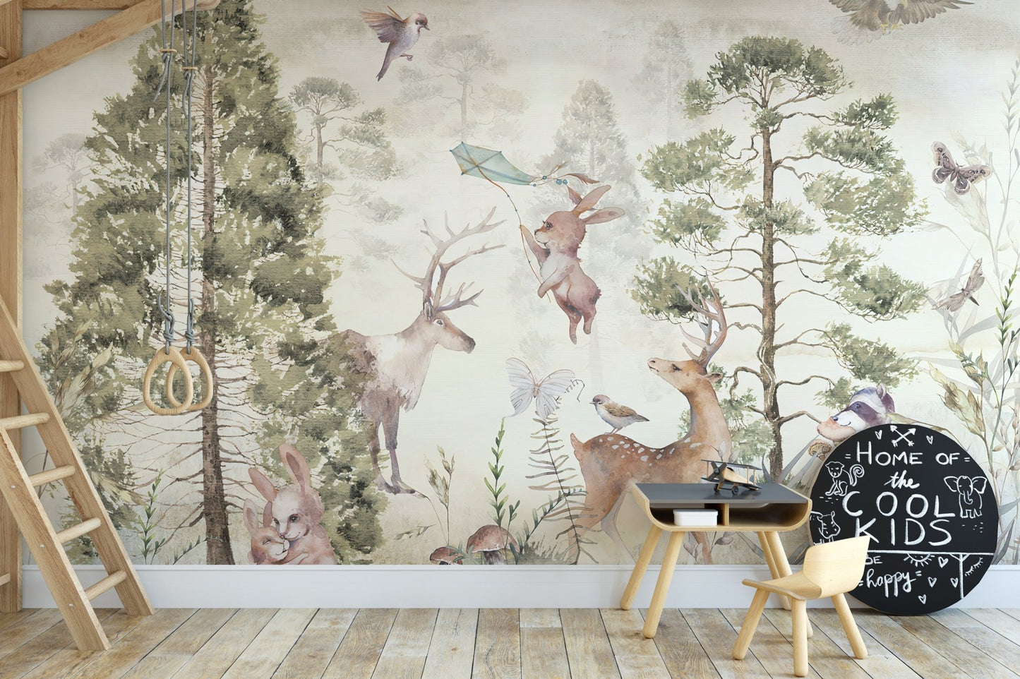 Wildlife themed wall mural behind a small table and chairs in a play zone.