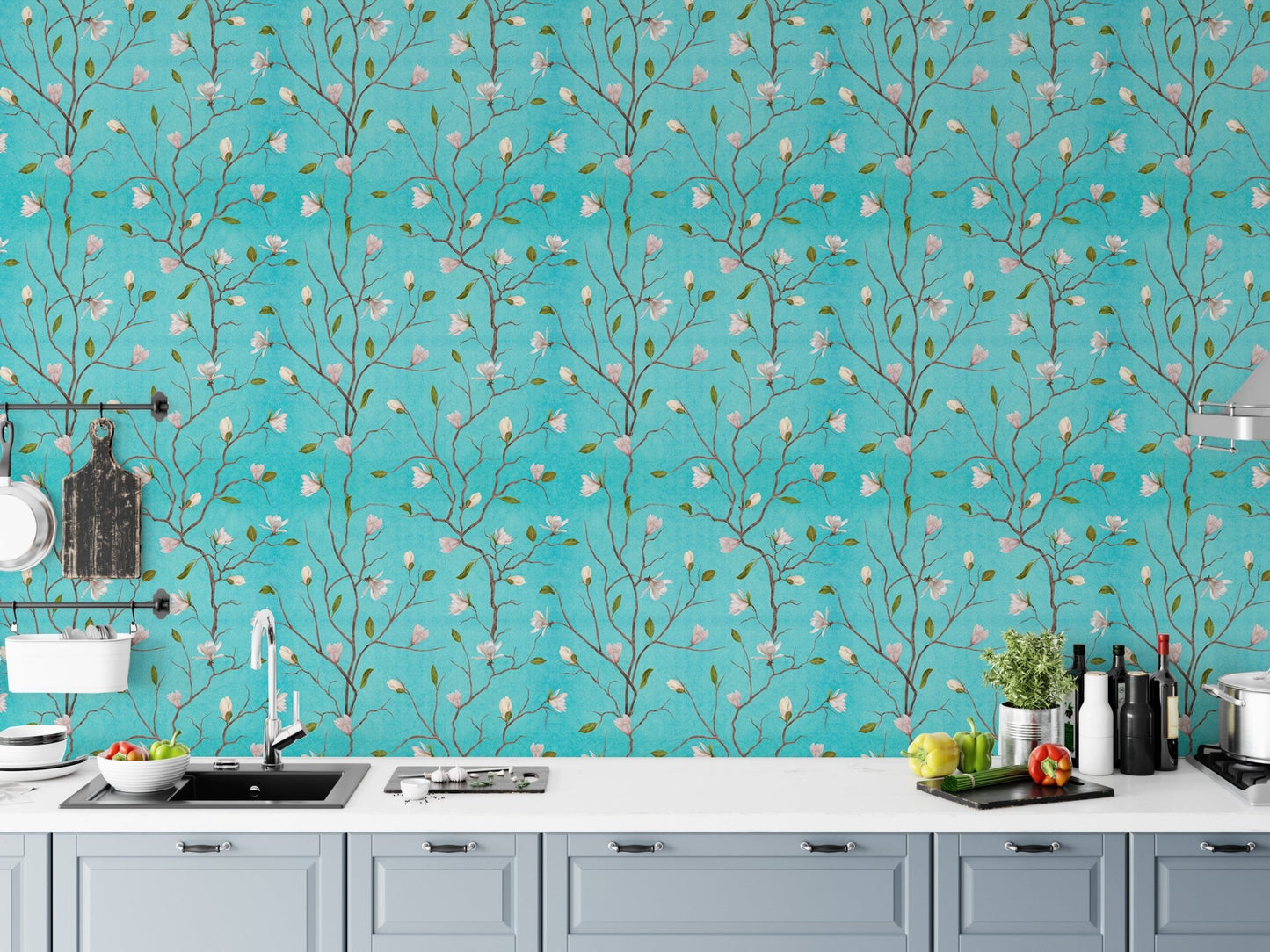 Turquoise floral wallpaper as a kitchen backsplash above white counters.