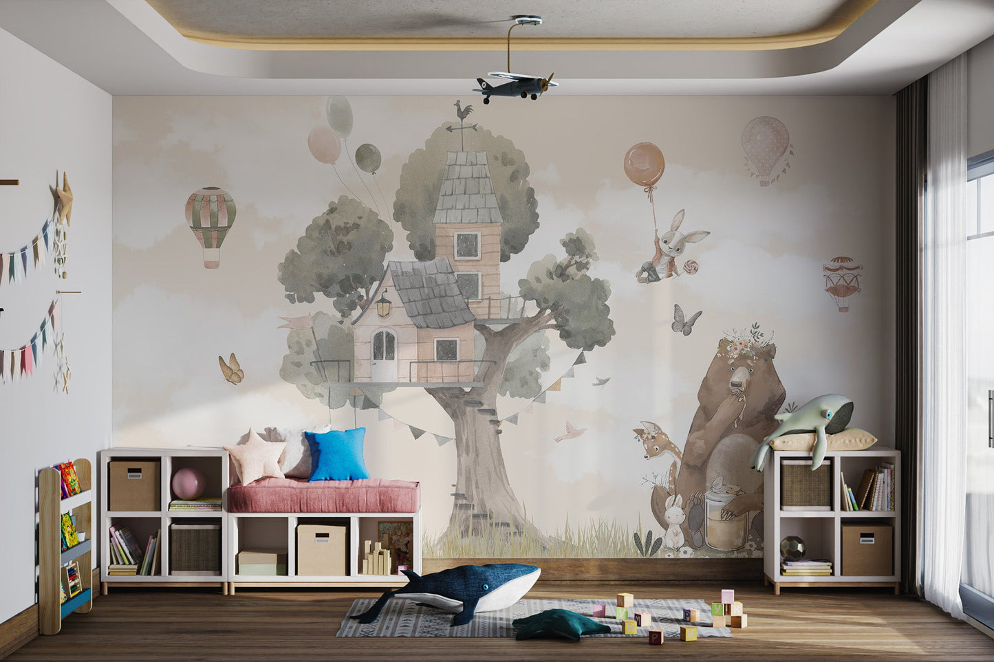 Large tree house and hot air balloon wall mural in a play zone.