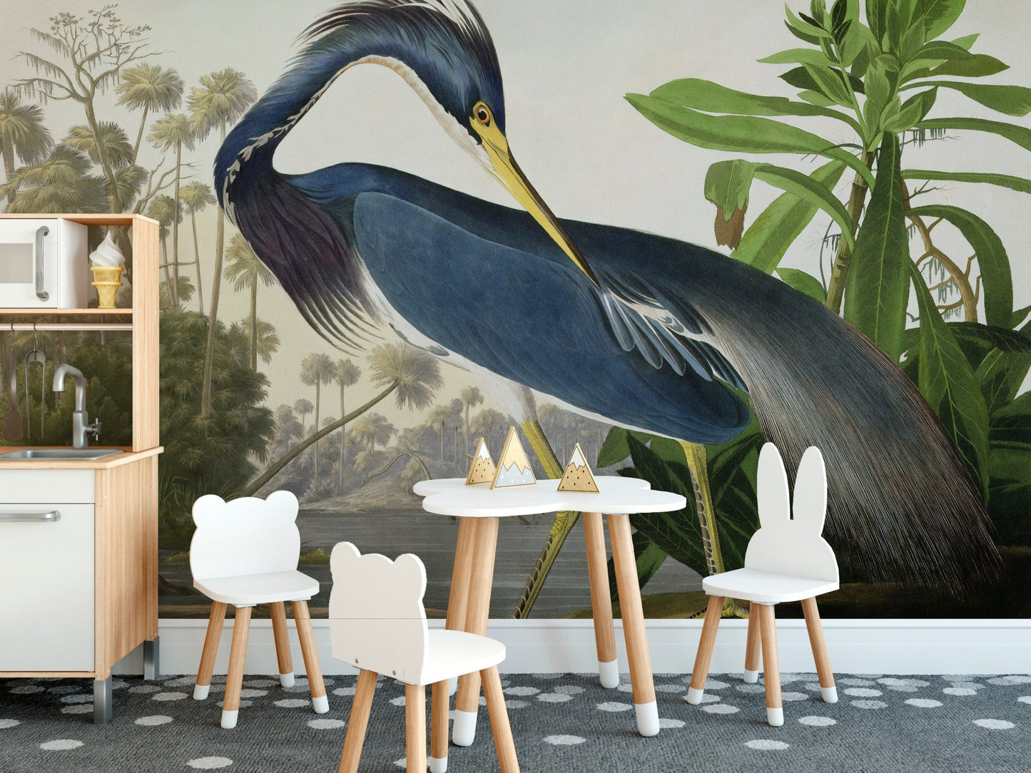Blue heron wall mural in a dining space with a small white table and chairs set.