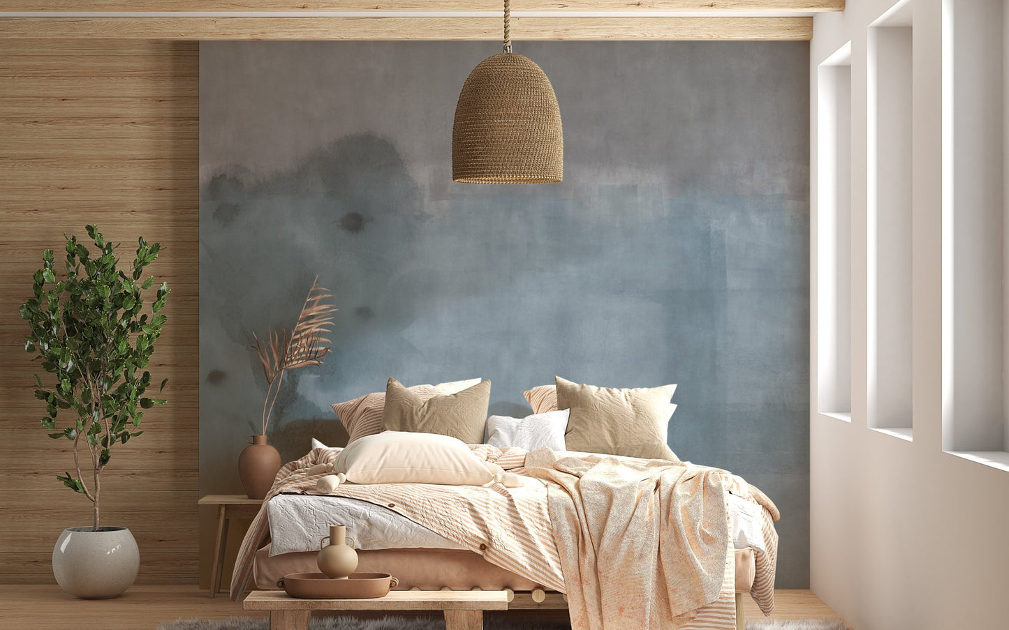 Wooden bed against a light blue shade watercolor wall mural backdrop.