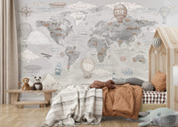 Children's bedroom with world map wallpaper, bed, and toys.