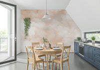 A wall mural featuring a soft, blended sky in shades of peach and orange.

