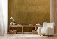 The image shows a full wall with a pattern that resembles aged, gilded metal or plaster.

