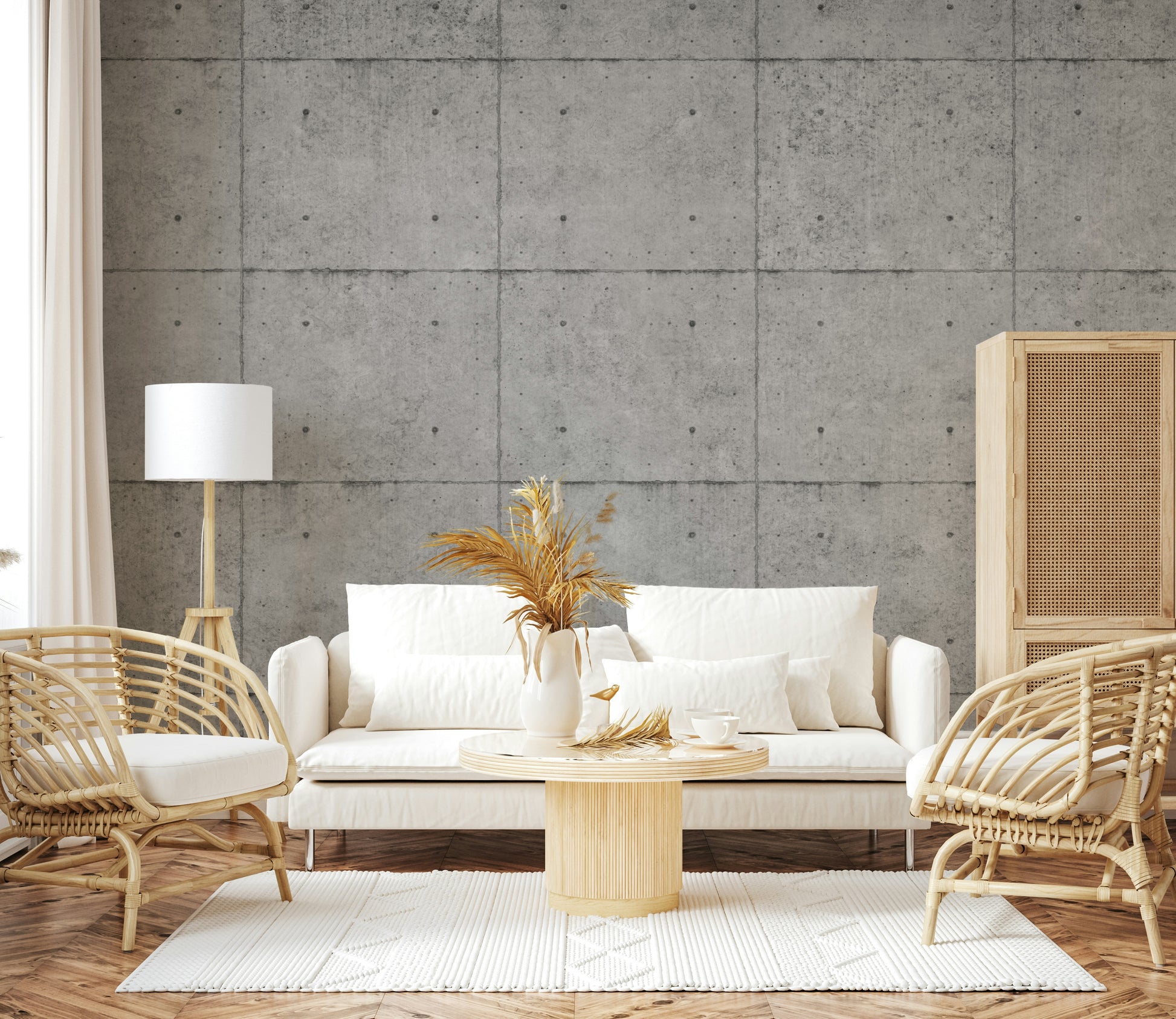 The mural is installed in a minimalist living room behind a simple, black sofa.


