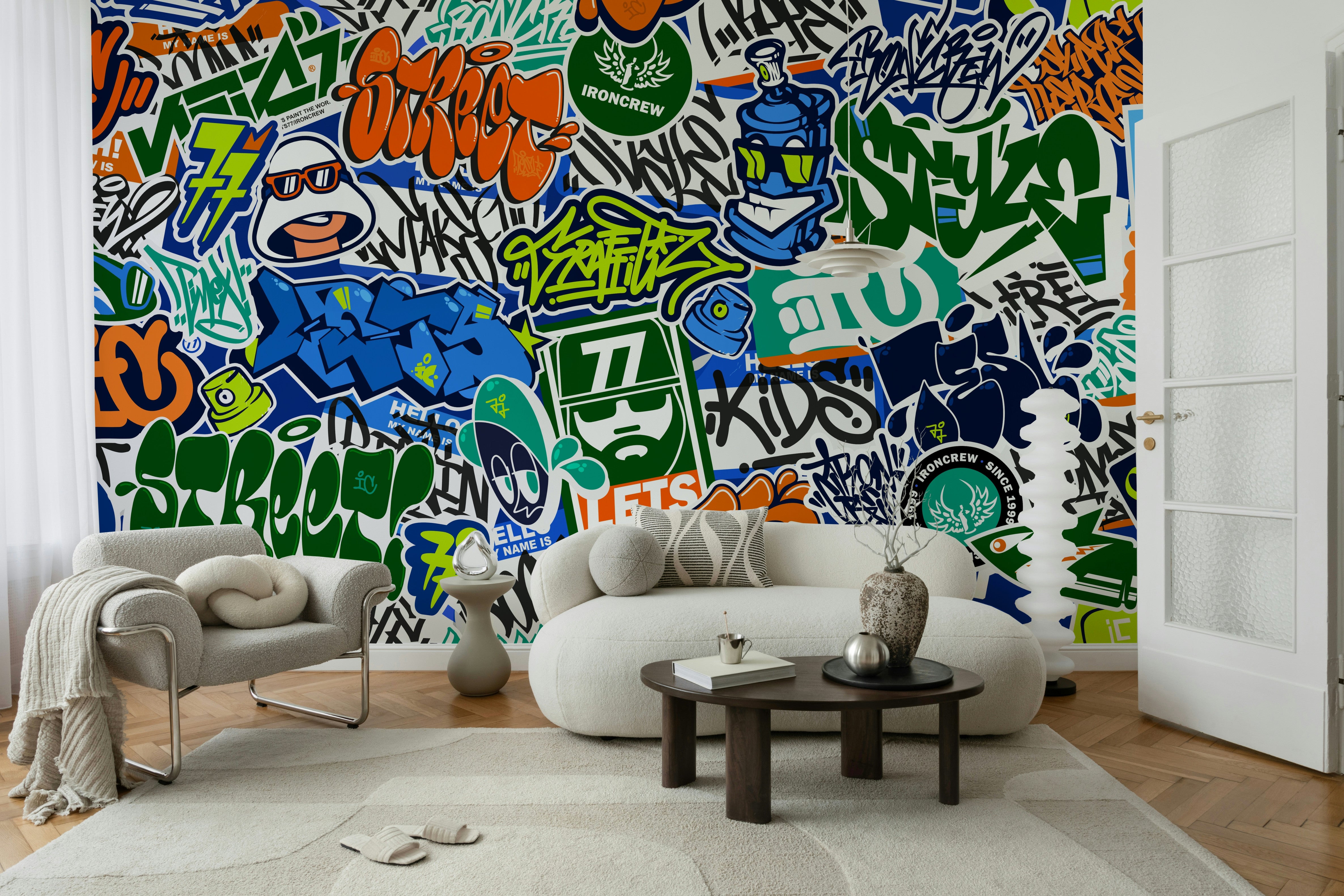A wall mural featuring a bold, layered design of urban graffiti and stickers.

