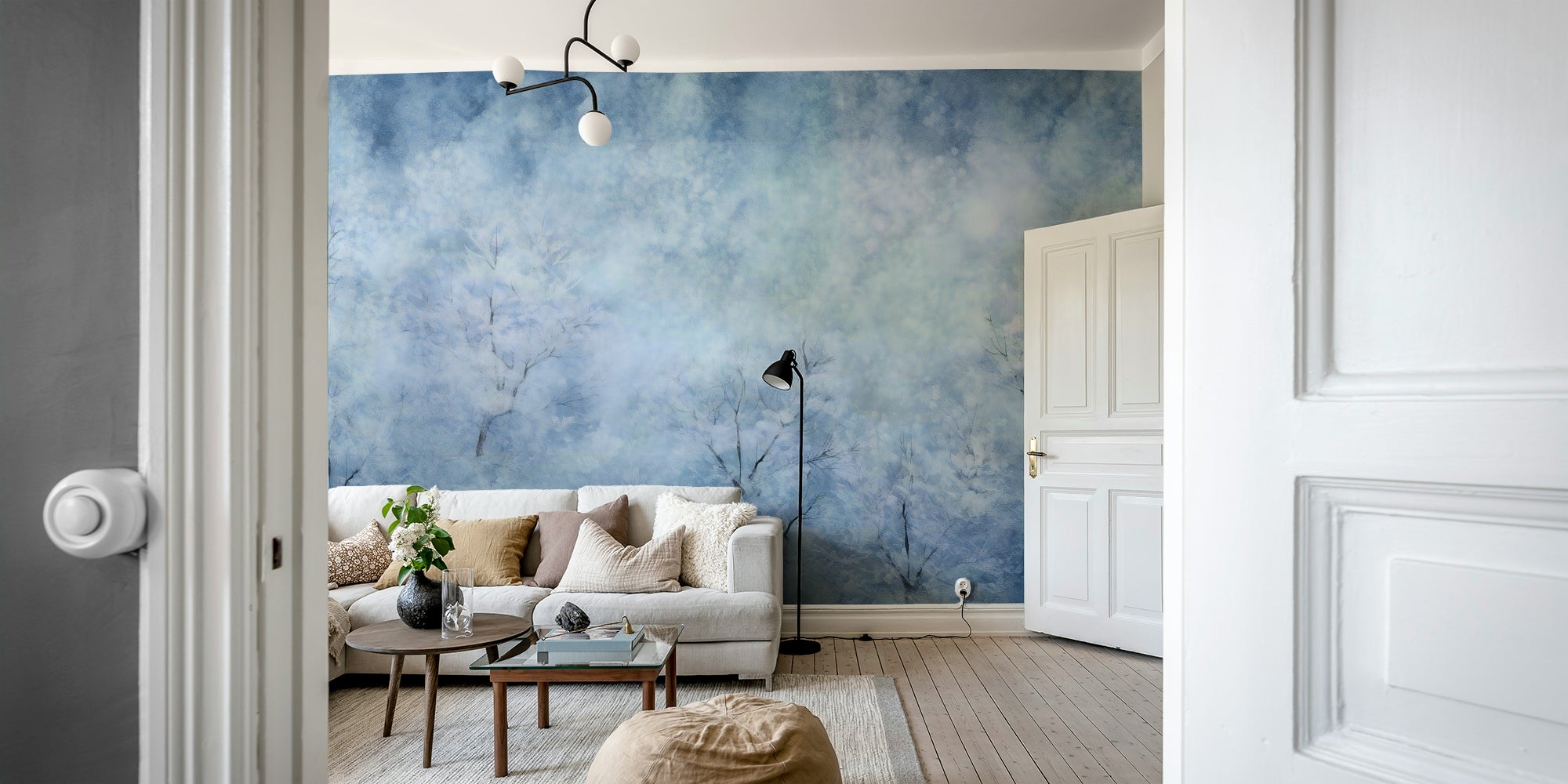 The mural extends across the entire wall, making the room feel more open.

