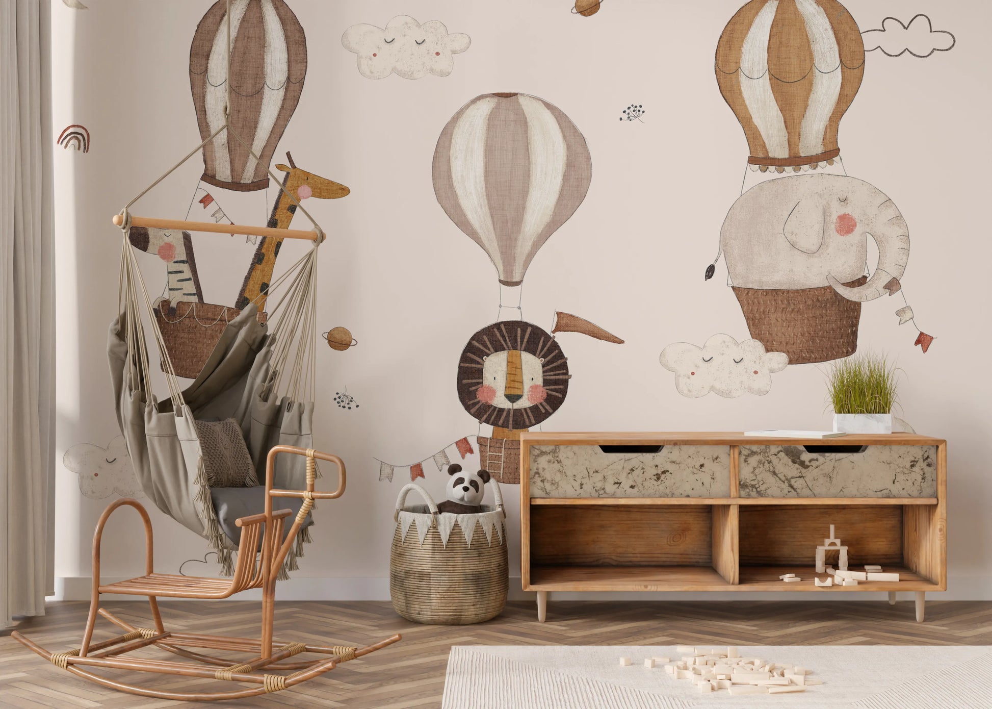 Artistic wall mural featuring a giraffe in a blue patterned balloon basket.