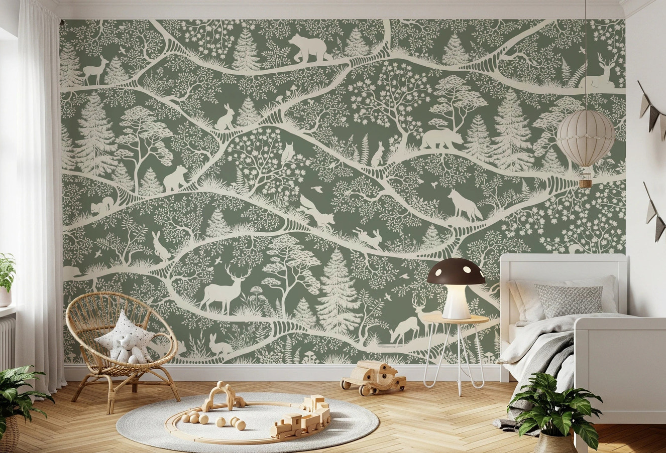 Green and white woodland wall mural behind a wooden loft bed in a children's room.