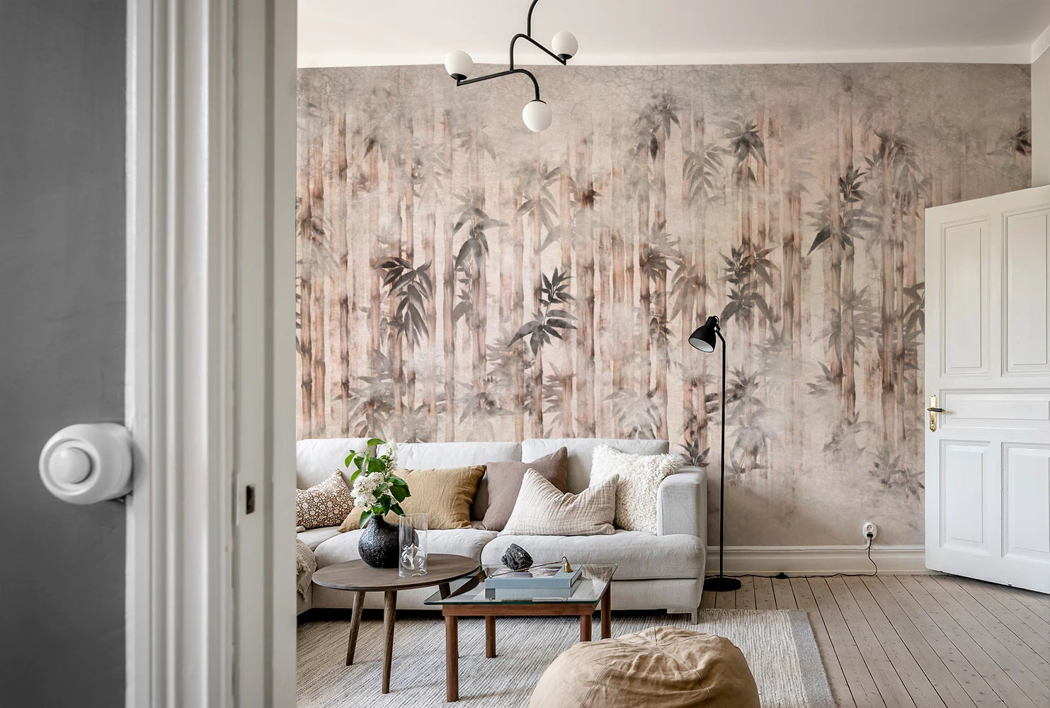 Abstract bamboo forest wall mural in muted earth tones.