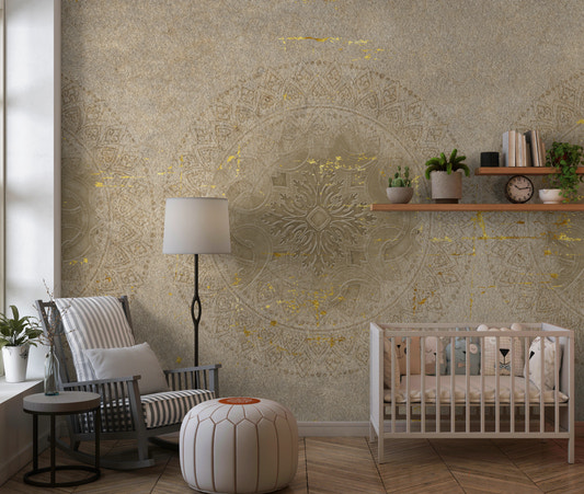 Nursery wall with taupe mandala mural with gold foil pattern.