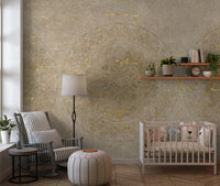 Nursery wall with taupe mandala mural with gold foil pattern.