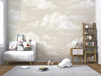 Watercolor cloud wall mural in a nursery with airy white and oatmeal cloud shapes.