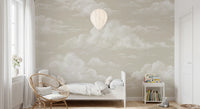 Wide pattern of sky wall mural showing varied cloud shapes in painterly white over warm sand backdrop.