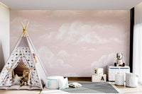 Watercolor cloud wall mural with painterly white clouds on pastel pink background.