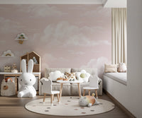 Kids room wall mural showing Cumulus cloud pattern over warm pink sky with painterly brushwork.