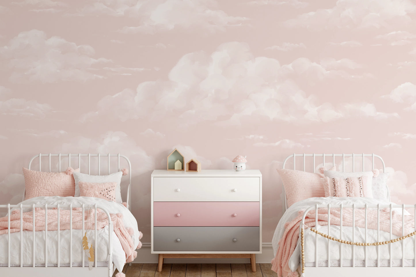 Soft pink cloud wall mural with watercolor cloud finish in kids bedroom.