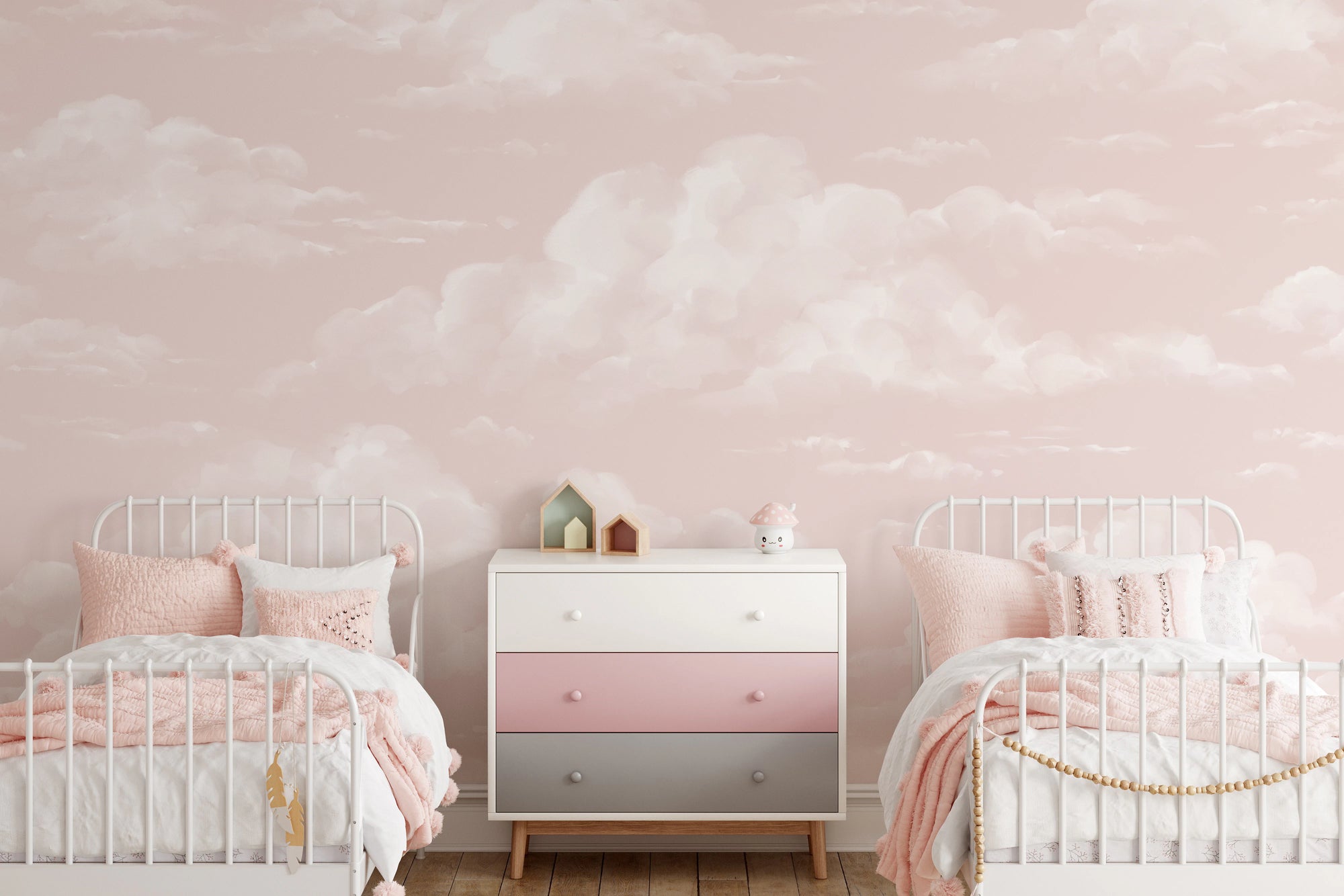 Soft pink cloud wall mural with watercolor cloud finish in kids bedroom.