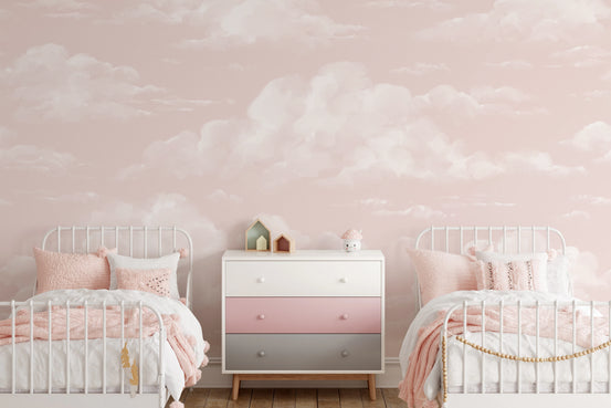 Soft pink cloud wall mural with watercolor cloud finish in kids bedroom.