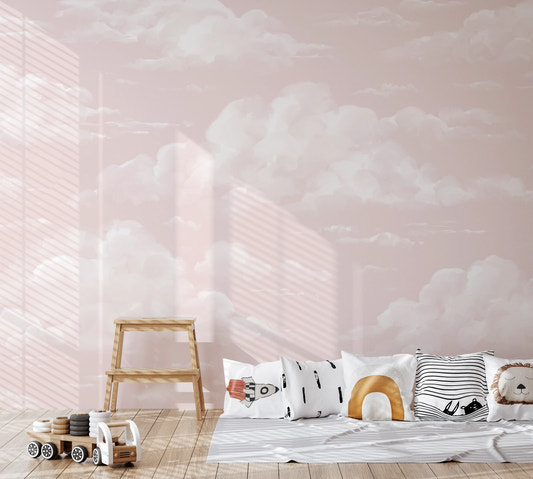 Pink cumulus cloud wall mural in nursery with painterly soft sky pattern.