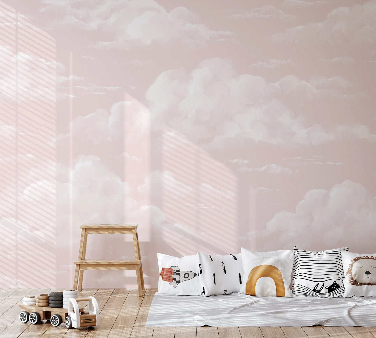 Pink cumulus cloud wall mural in nursery with painterly soft sky pattern.