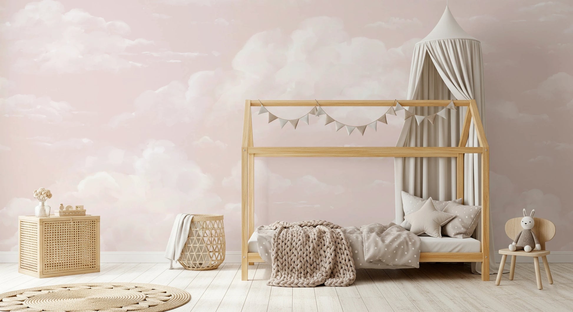 Pink cloud mural on toddler room walls with painterly cloud pattern. 