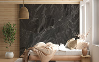 Deep black slate mural with thin mineral veins and grey tones