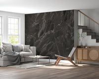 Layered dark stone mural with white veins over black base