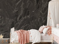 Near-black marble-look stone mural with fine white veining in bedroom
