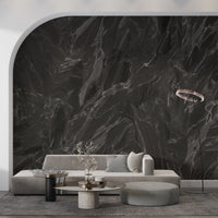Black stone surface mural with jagged mineral vein lines