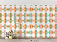 Kids play area with wooden ladder against a teal and orange geometric retro wall mural.