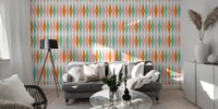 Modern living room with grey sofa and large retro diamond pattern wall mural.