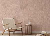 Textured beige brush dots on white wallpaper.
