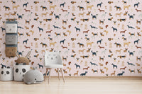 Soft pale pink wallpaper with illustrations of dog breeds
