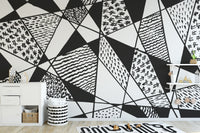 Bold black and white patterns mural with geometric designs.
